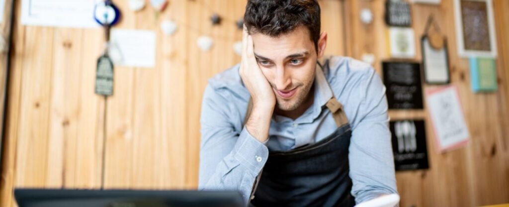 The owner of the woodworking business looks frustrated due to the no-shows for the woodshop class