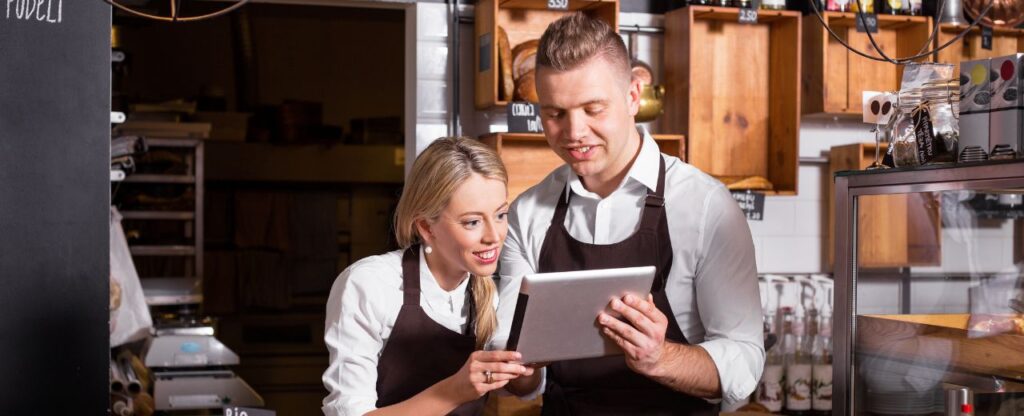 Coffee shop employees checking the barista training attendance